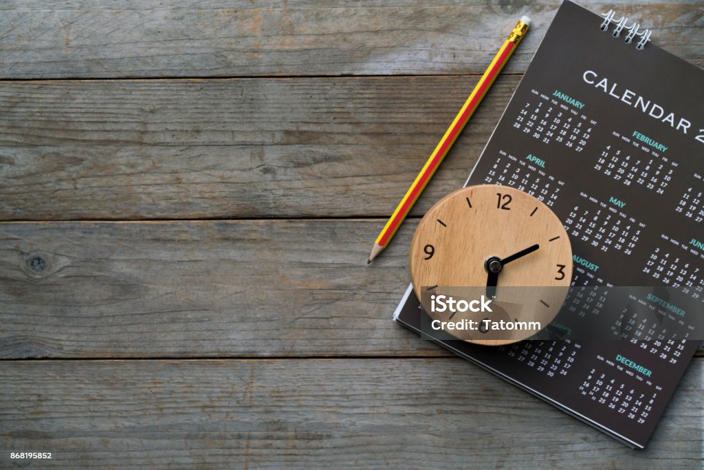 close up of clock, calendar and pencil on the table, planning for business meeting or travel planning concept Personal Organizer Stock Photo