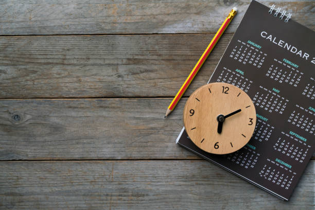 close up of clock, calendar and pencil on the table, planning for business meeting or travel planning concept - calendar personal organizer diary event imagens e fotografias de stock