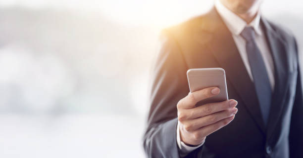 istock Close up of a business man using mobile smart phone. 868195878