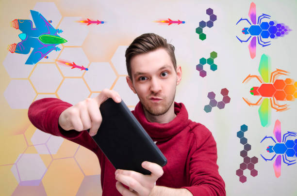 Young man playing video games on his tablet