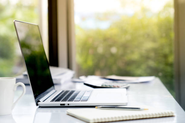 istock Top view desk of work table in office woth laptop computer , notebook , calculator and a cup of coffee for creative business work or marketing plan to success planning of company 868199748