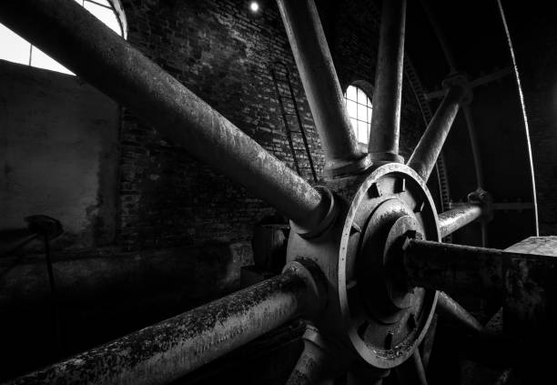 istock Big iron water wheel inside an abandoned ghost intriguing building in black and white 868200406