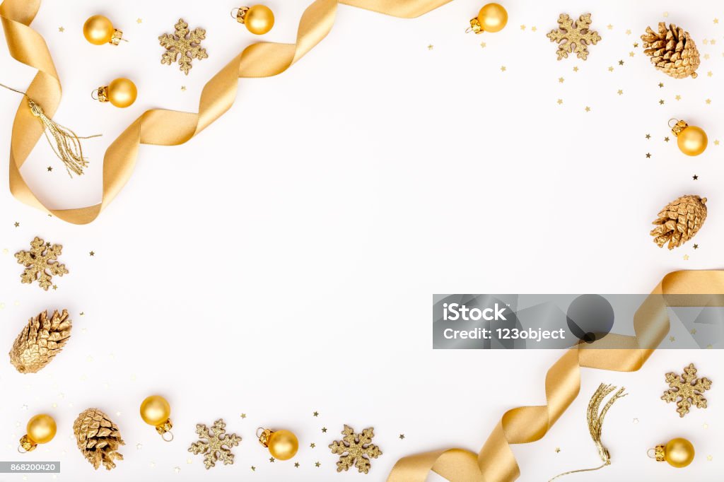 christmas or new year frame composition. christmas decorations in gold colors on white background with empty copy space for text. holiday and celebration concept for postcard or invitation. top view Gold - Metal Stock Photo