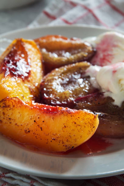 istock Baked plums and peaches with ice cream and honey 868209420