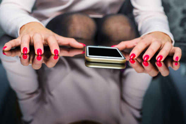 Woman is holding her hands nervously on the table, depression, nervousness, anger, expectation, uncertainty on the message.