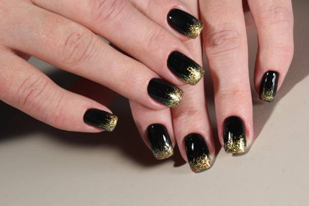 istock Evening manicure design in black and gold color 868217100