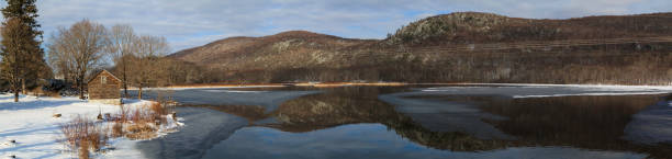 istock Winter mountain lake scene with cabin in Berkshires 868220292