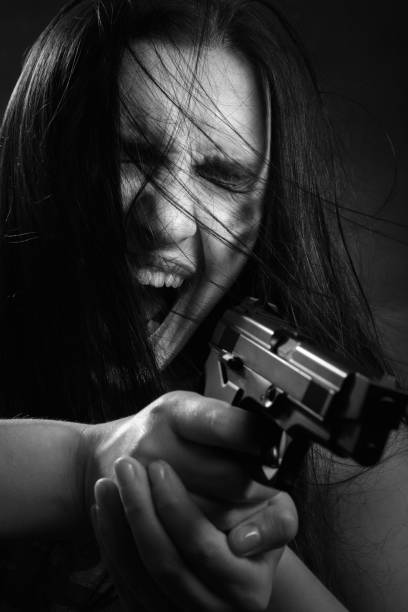 istock woman with gun 868221726