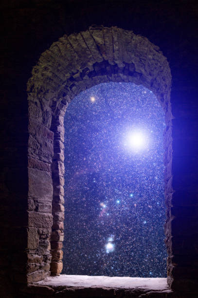 istock The sky with stars and some supernova star visible through an old ancient stone window. 868231112