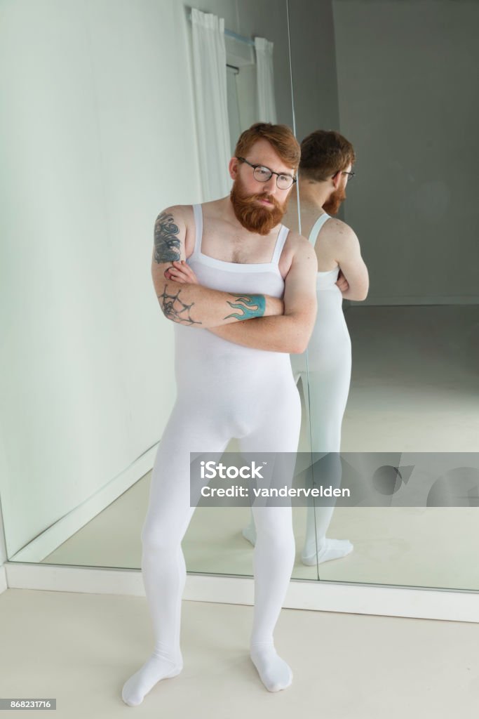 Fed up trainee ballet dancer A ballet student waits miserably, and in some discomfort to start his training. Men Stock Photo
