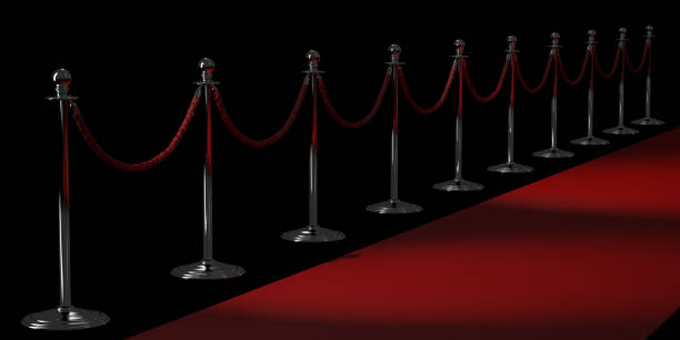 istock Silver rope barriers and Red carpet isolated on black background 868238882