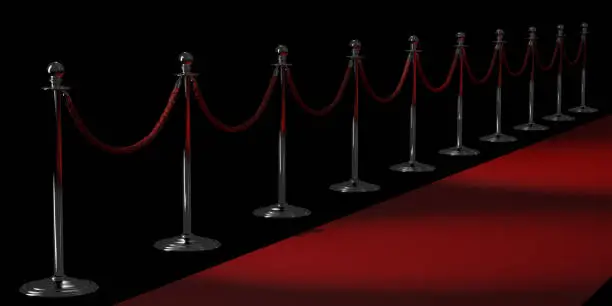 Photo of Silver rope barriers and Red carpet isolated on black background