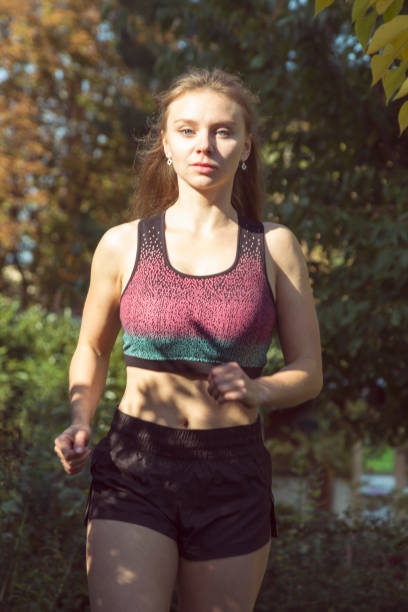 istock Young fit woman doing exercises in the park. 868242030