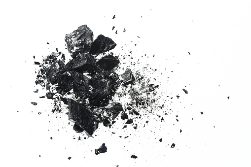 Pile of black coal bars isolated on white background