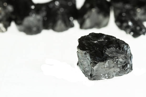 istock Black coal mine with selective focus. Anthracite coal bar isolated on white background 868242874