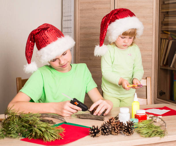 istock Children making Christmas decorations. Make christmas decoration with your own hands. Handcraft concept. 868246384