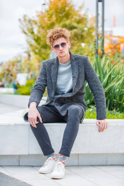 istock Handsome boy posing on the camera on the nature background. 868249362