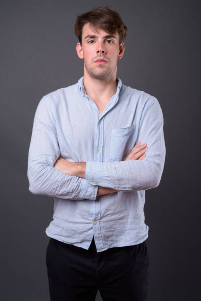 istock Young handsome man wearing casual clothing against gray background 868249596