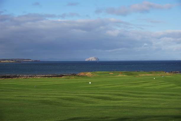 Dunbar, East Lothian, Scotland - October 25, 2017: View of the Bass rock form Dunbar, looking over the golf links of Winterfield Golf Course and Belhaven Bay. The county of Fife is visible on the horizon.