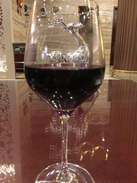istock A glass of wine with deer statue on the background 868249700