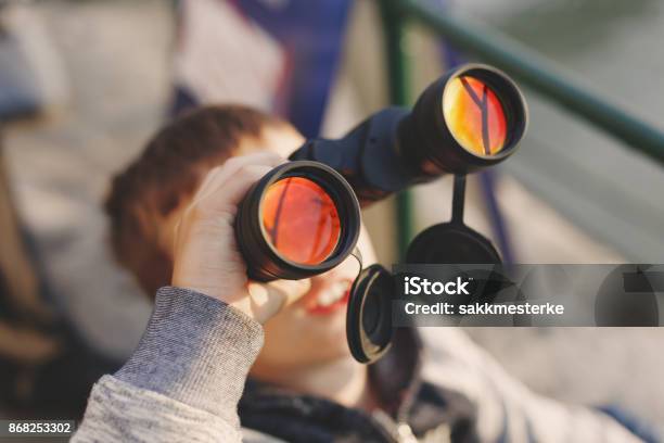 Little Boy Watching Airplane On Sky By Binoculars Stock Photo - Download Image Now - Airshow, Adventure, Air Vehicle
