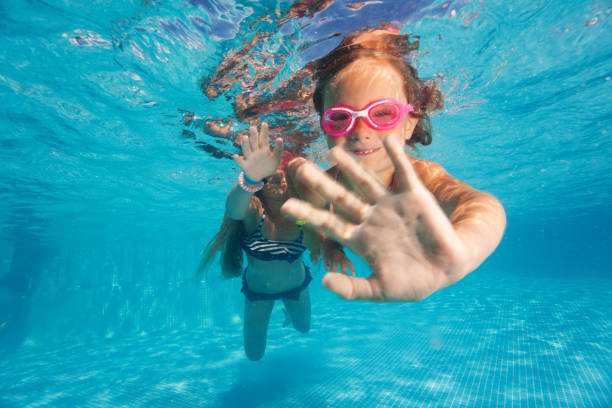 istock Two little girls diving underwater in pool 868257268