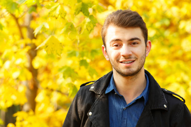 istock Handsome boy posing on the camera on the nature background. 868267024