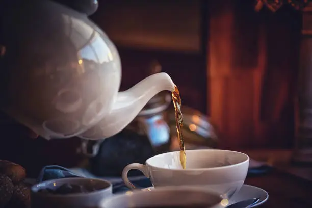 Pouring Black Tea into Cup