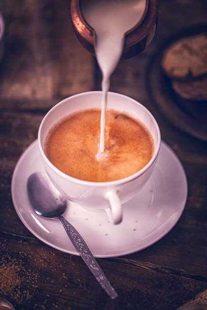 istock Pouring Milk into Cup of Coffee 868271186