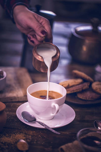 istock Pouring Milk into Cup of Coffee 868271194