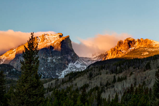 The Mountain Peaks glow at sunrise in Rocky Mountain National Park Colorado Close Up View of Hallett Peak in Rocky Mountain National Park, Estes Park, Colorado at sunrise hallett peak stock pictures, royalty-free photos & images