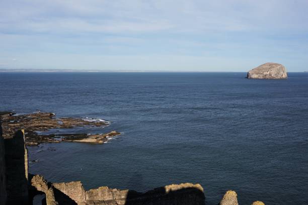 Tantallon Castle and Bass Rock North Berwick, East Lothian, Scotland - October 27, 2017: View looking down from the ramparts of Tantallon Castle towards the rocky coastline of the Firth of Forth and over the remains of the outer court at the bottom of the picture. The Bass Rock is in the right background. The county of Fife can be seen on the horizon. north berwick scotland east lothian castle scotland stock pictures, royalty-free photos & images