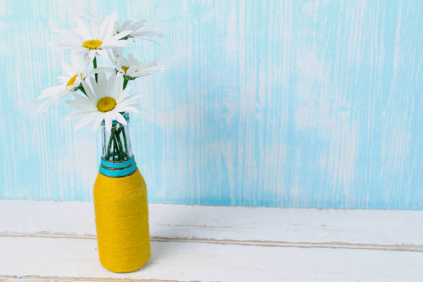 Bouquet of daisies in vase on table