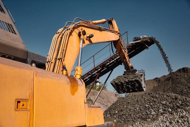 istock Quarry bucket excavator works in a slag dump 868292900