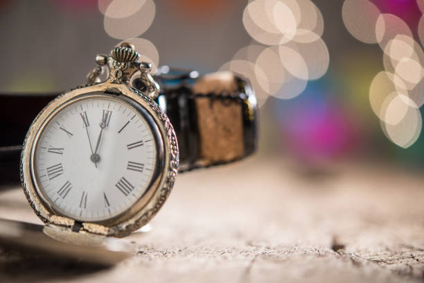 istock Antique cloch show five to midnight and champagne bottle on bokeg background 868302910