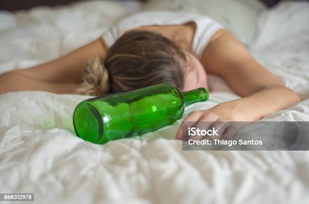 Woman Blond Hair Fainted In Bed After Drinking Stock Photo - Download Image Now - Women, Drunk, Alcohol Abuse
