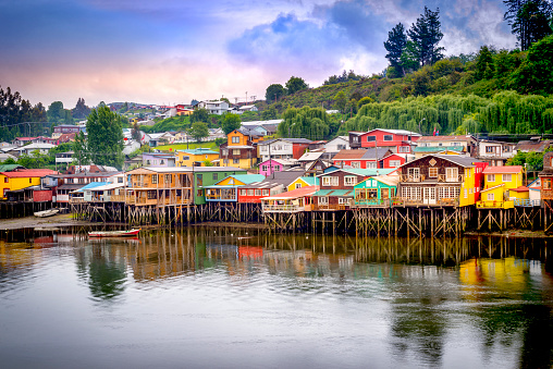 Palafitos in Castro. Castro is the capital of Chiloe Province, in the Los Lagos Region, Chile. Palafitos are houses raised on piles over the surface of the soil or a body of water