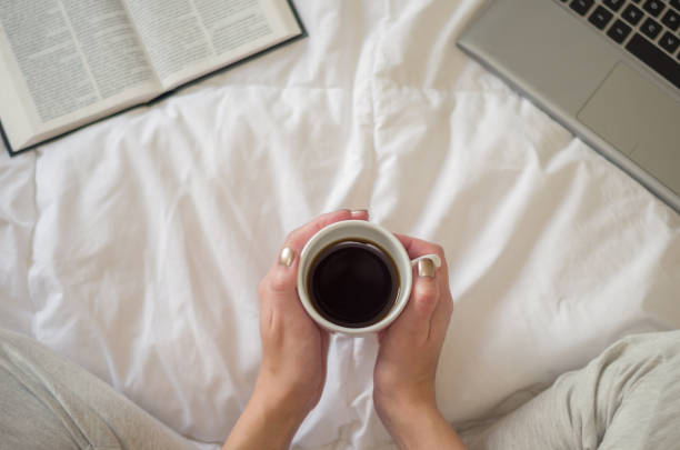 istock Woman with crossed legs, reading book and drinking coffee. 868317288