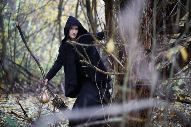 istock A woman in a witch suit in a forest 868323702