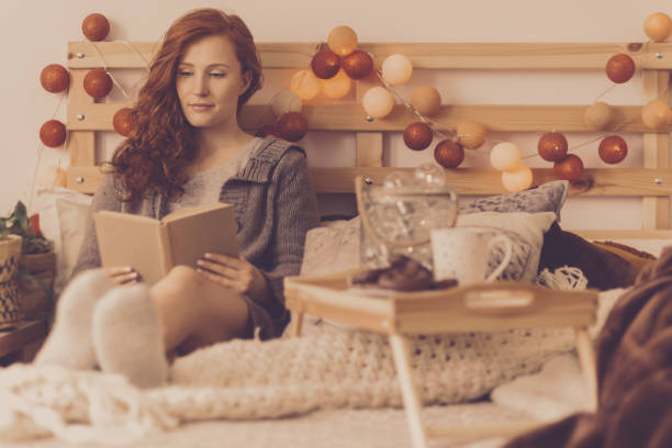 Girl lying in bed reading