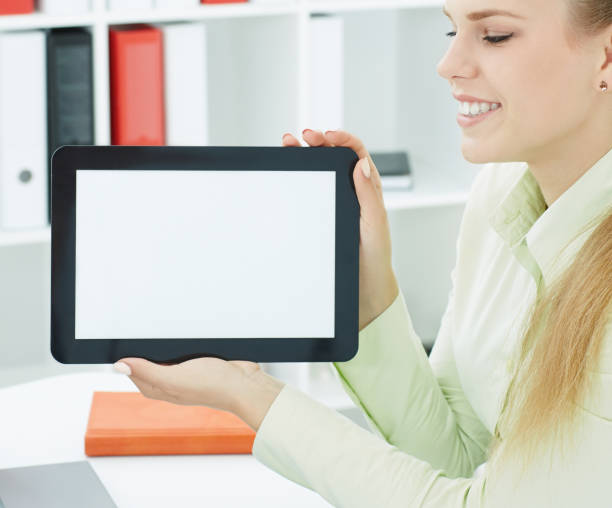istock Young smilling woman showing tablet with copy space for text or image. Advertisement concept. 868324690