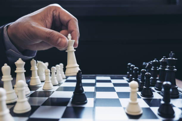 istock Close up of hands confident businessman colleagues playing chess game to development analysis new strategy plan, leader and teamwork concept for success. 868331828