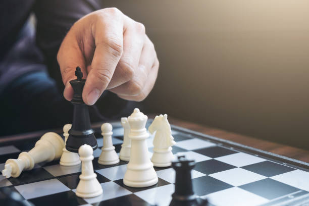 istock Close up of hands confident businessman colleagues playing chess game to development analysis new strategy plan, leader and teamwork concept for success. 868331936