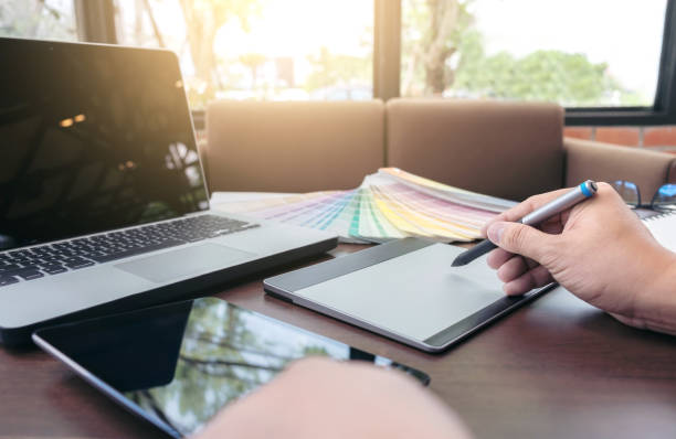 istock Creative creativity graphic designer working with graphics tablet,laptop and smart phone, colour chart at workplace on wooden desk , colour ideas style concept 868331962