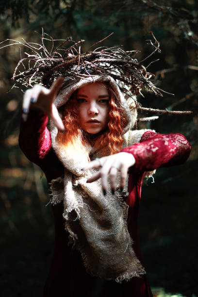 istock The red-haired witch holds a ritual with a crystal ball 868334688