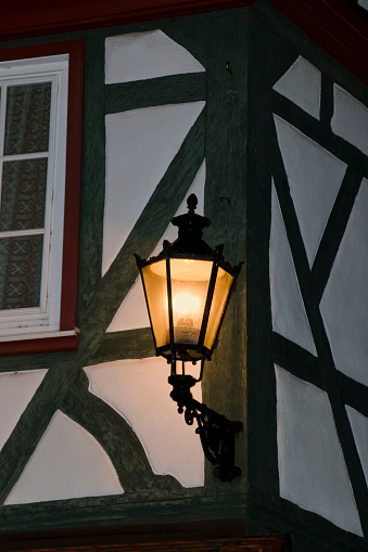 Luminous lantern at an old half timbered house at night