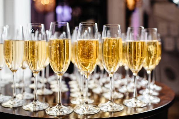 istock Elegant glasses with champagne standing in a row on serving table during party or celebration 868338696