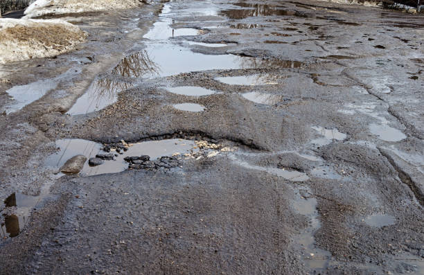 istock Puddles on the road in spring 868345930