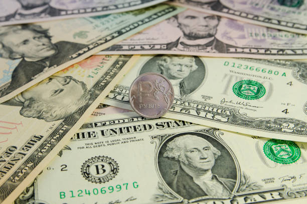 istock Russian roubles coins and Euro coins on banknotes. 868346026