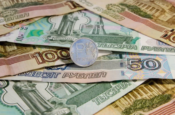 istock Russian roubles coins and Euro coins on banknotes. 868346056